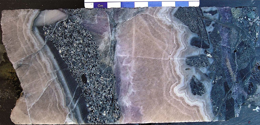 Core from AKC-58 53.6-53.8m displaying banded crustiform-colloform quartz-adularia veining returning 2.98g/t Au, 12.35 g/t Ag.